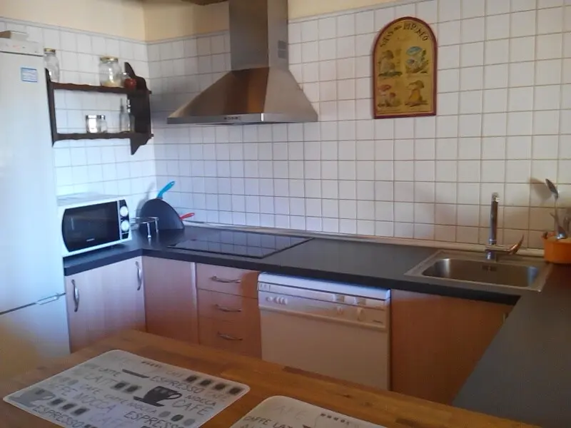 Cocina con campana extractora, microondas y lavavajillas